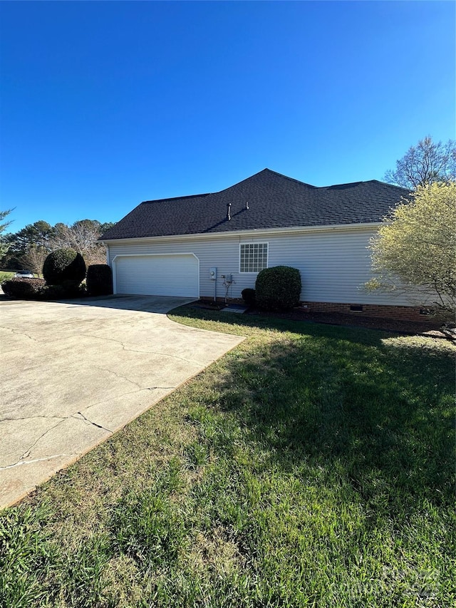 view of property exterior featuring a garage and a lawn