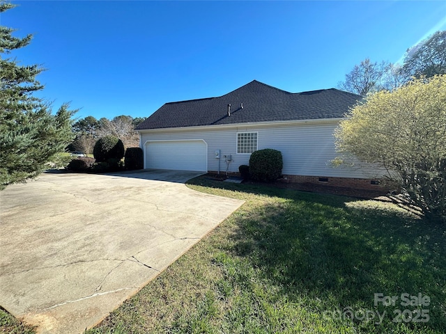 view of side of property featuring a yard and a garage