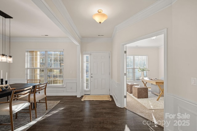 entrance foyer with dark wood-type flooring and crown molding