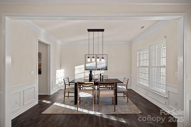 dining area with dark hardwood / wood-style flooring and crown molding