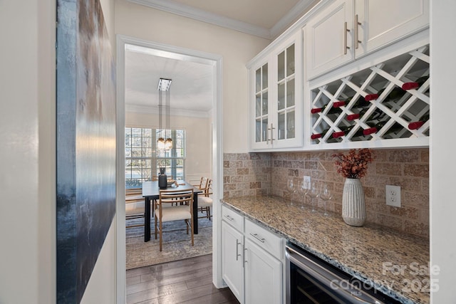 interior space with light stone counters, decorative light fixtures, dark hardwood / wood-style flooring, and white cabinetry