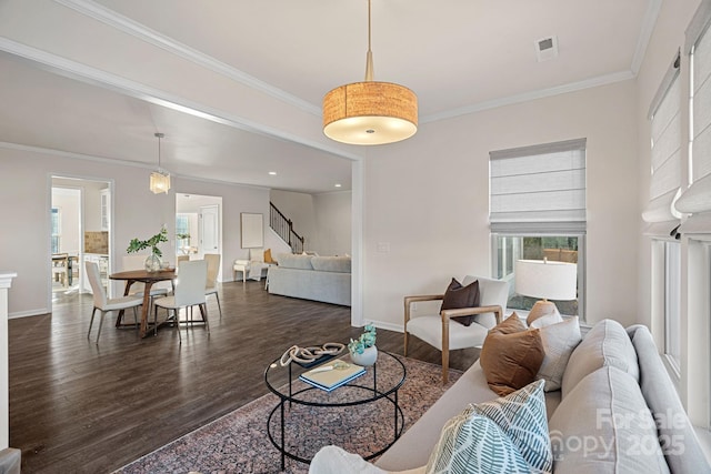 living room with dark wood-type flooring and ornamental molding