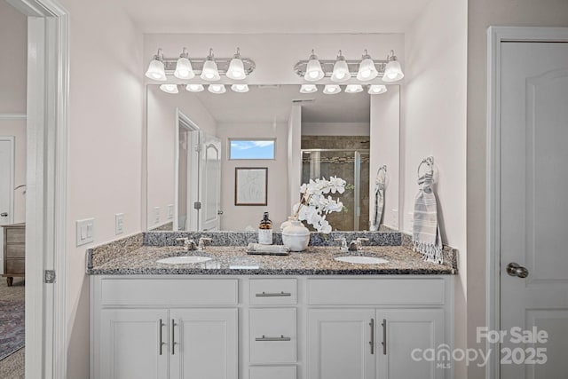 bathroom with a shower with shower door and vanity