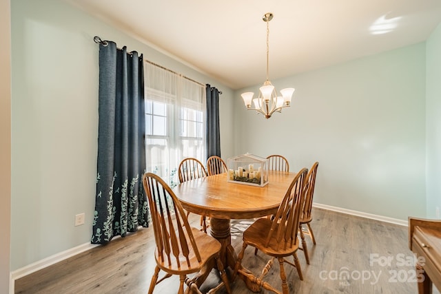 dining area featuring a chandelier and hardwood / wood-style floors