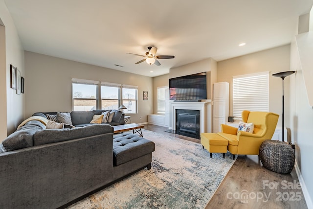 living room with hardwood / wood-style floors and ceiling fan