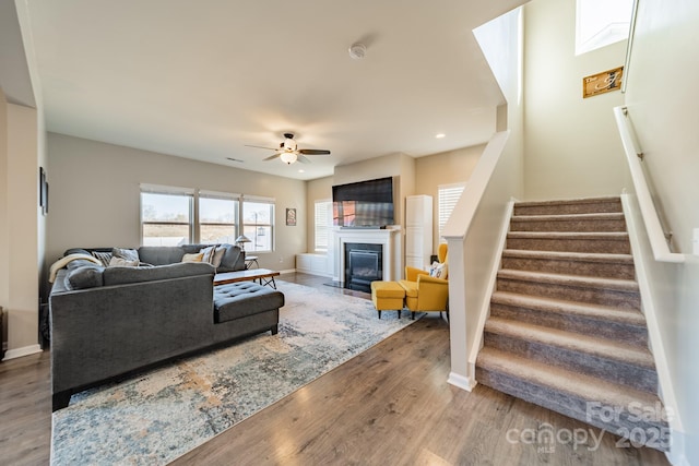 living room featuring hardwood / wood-style flooring and ceiling fan