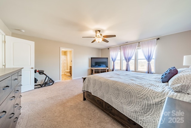 carpeted bedroom featuring ensuite bathroom and ceiling fan