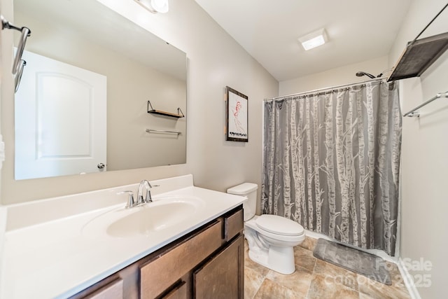 bathroom featuring vanity, a shower with shower curtain, and toilet