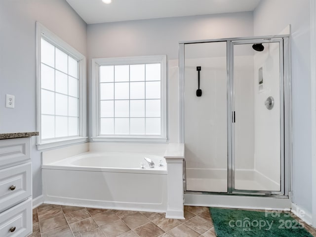 bathroom with tile patterned flooring and independent shower and bath