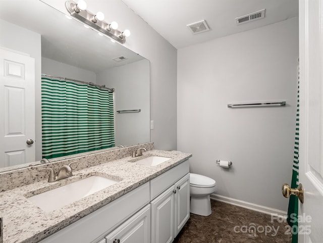 bathroom with vanity, curtained shower, and toilet