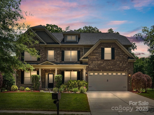 craftsman inspired home featuring a yard and a garage