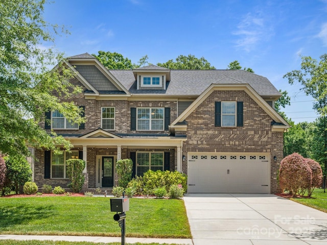 craftsman-style home featuring a front yard and a garage