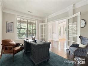 home office with hardwood / wood-style floors, french doors, and ornamental molding