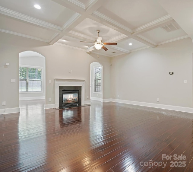 unfurnished living room with beamed ceiling, a multi sided fireplace, and coffered ceiling