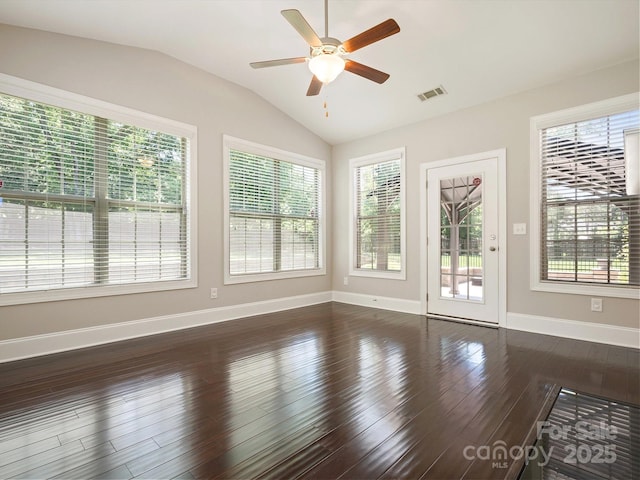 empty room featuring ceiling fan, dark wood-type flooring, and vaulted ceiling