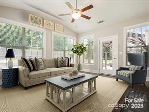 sunroom / solarium with ceiling fan and lofted ceiling