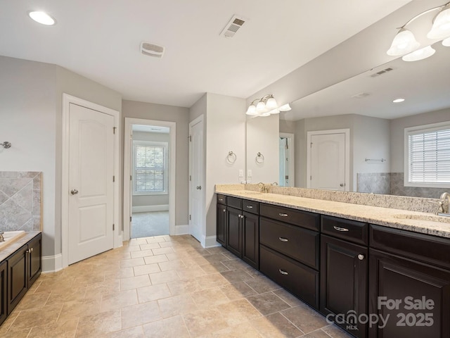 bathroom featuring vanity and a wealth of natural light