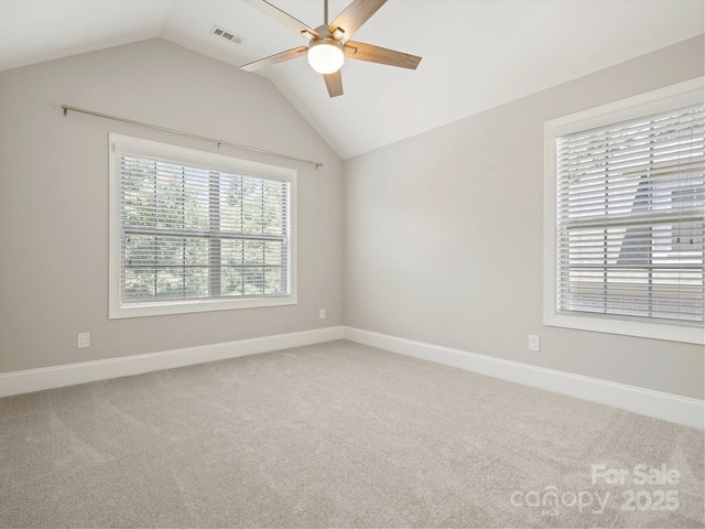 carpeted empty room featuring ceiling fan and lofted ceiling