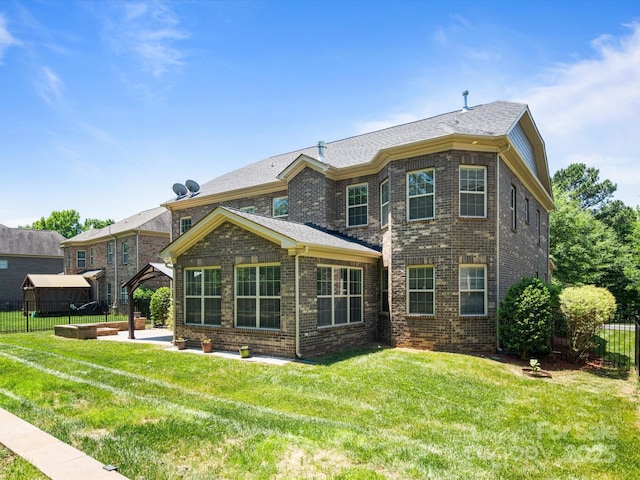 rear view of property featuring a lawn and a patio