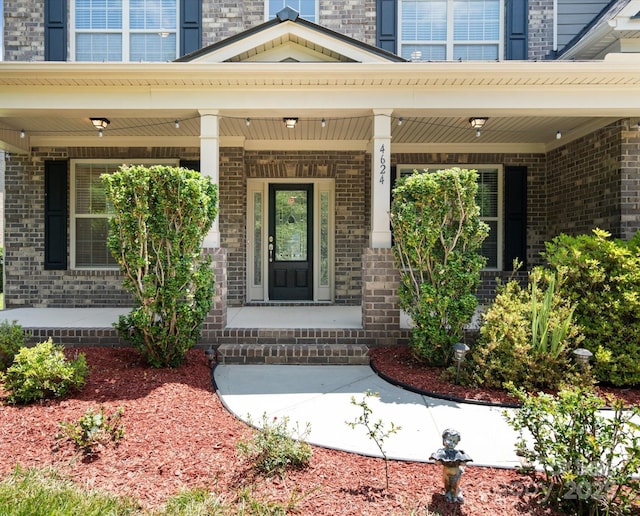 view of exterior entry with a porch