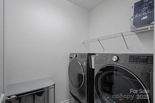 clothes washing area featuring washer and dryer