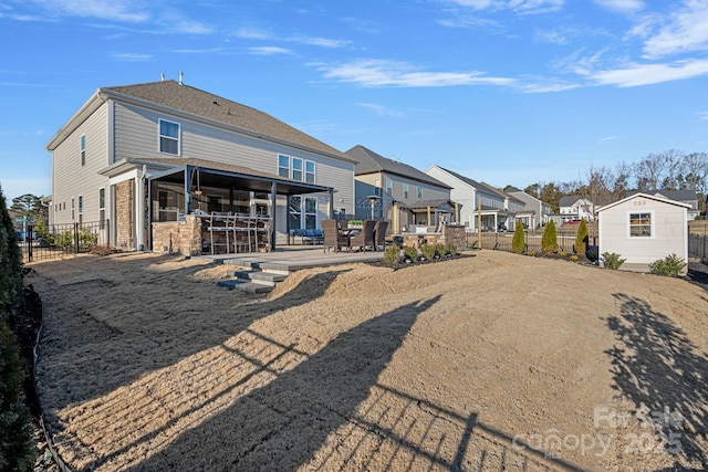 rear view of house with a patio and exterior bar