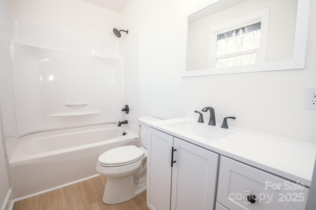 full bathroom featuring vanity, hardwood / wood-style floors, shower / bathing tub combination, and toilet