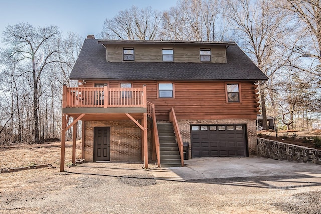 cabin featuring a garage and a deck