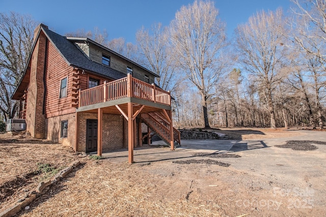 back of house featuring a deck