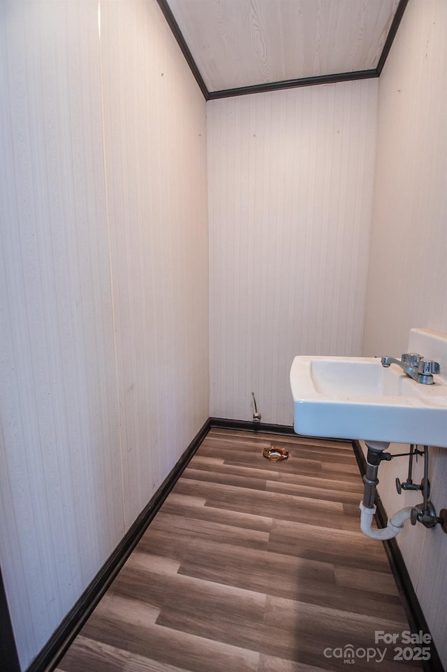 bathroom featuring hardwood / wood-style flooring and crown molding