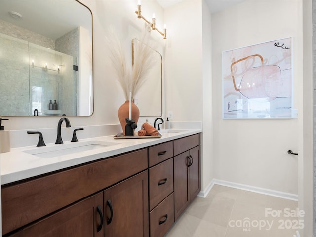 bathroom with tile patterned floors, a sink, a shower stall, and double vanity