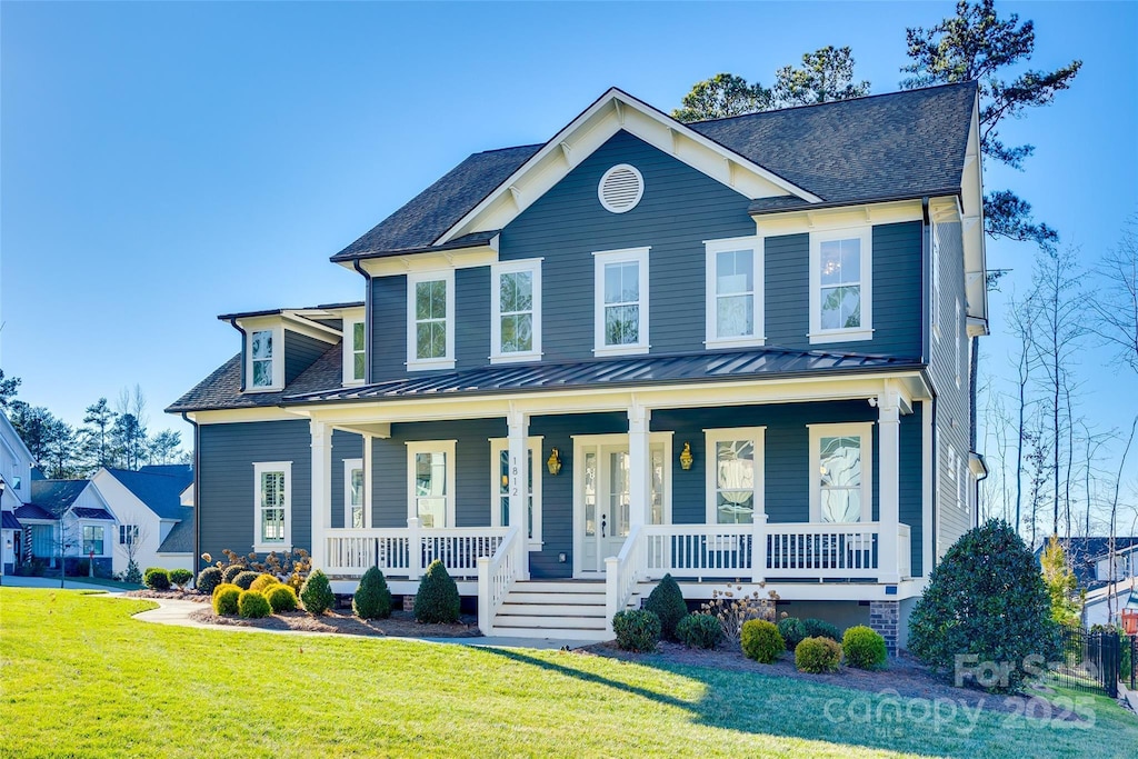 view of front of home with covered porch and a front yard