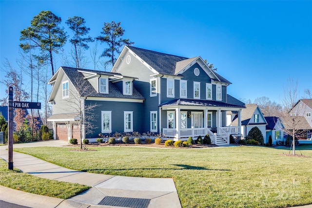 view of front of house with a garage, covered porch, and a front lawn