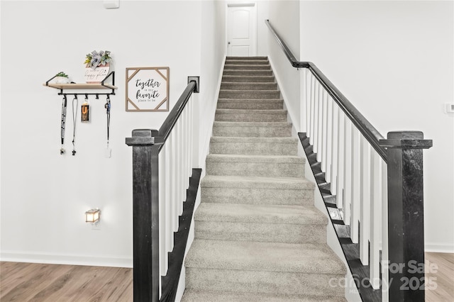 stairs with hardwood / wood-style floors