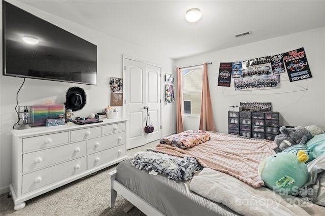 bedroom with carpet flooring and a closet