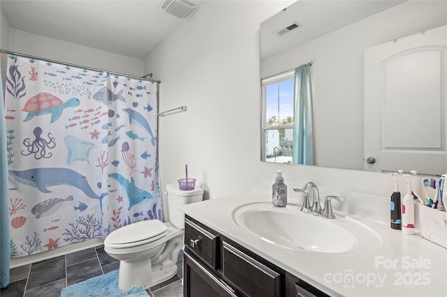 bathroom with toilet, tile patterned flooring, walk in shower, and vanity