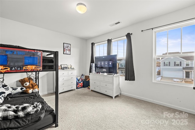 carpeted bedroom with multiple windows