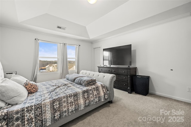 bedroom featuring light carpet and a raised ceiling