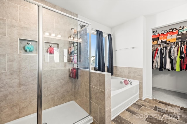 bathroom featuring shower with separate bathtub