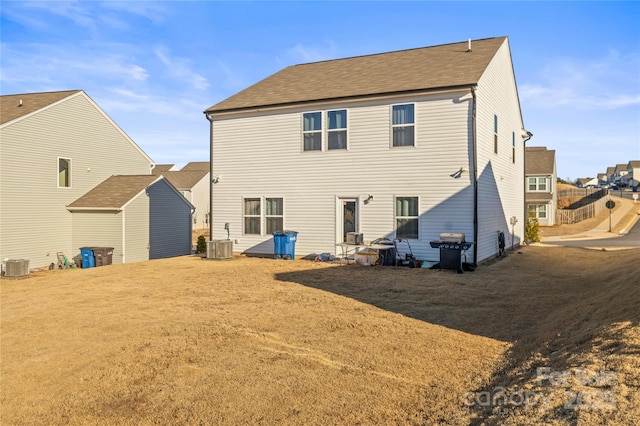 back of house with central AC unit