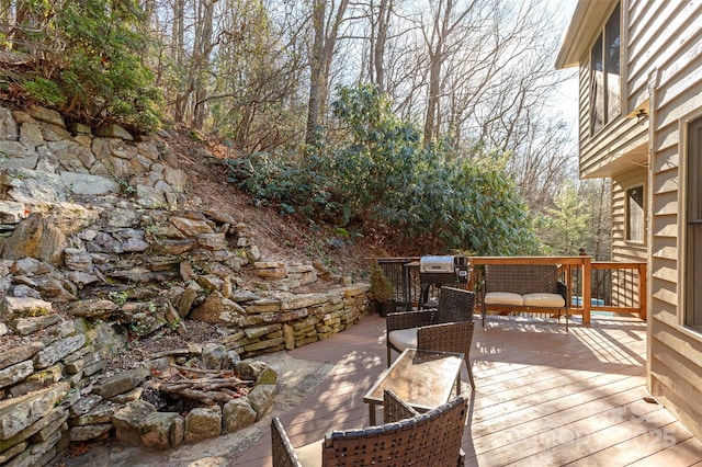 wooden terrace with a fire pit