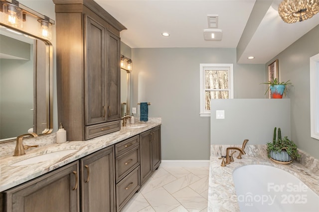 bathroom with vanity and a bath