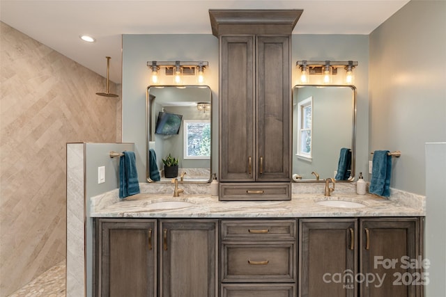 bathroom with vanity and a tile shower