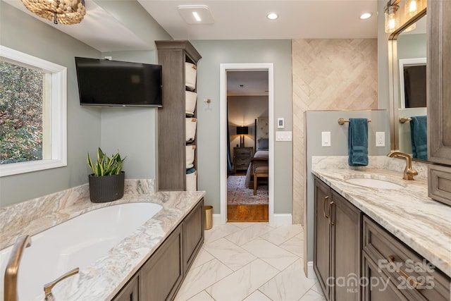 bathroom with a tub and vanity