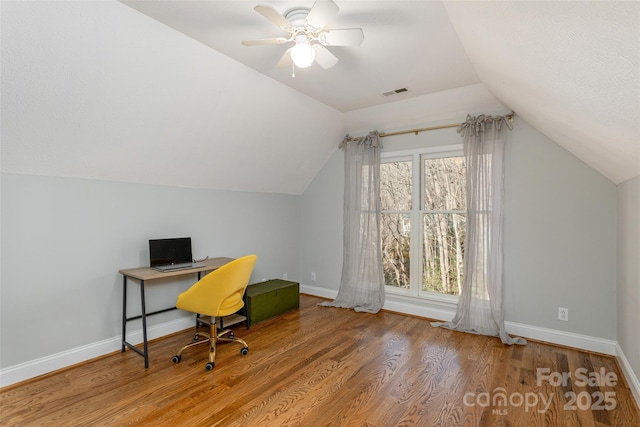 office area with hardwood / wood-style floors, a healthy amount of sunlight, and lofted ceiling