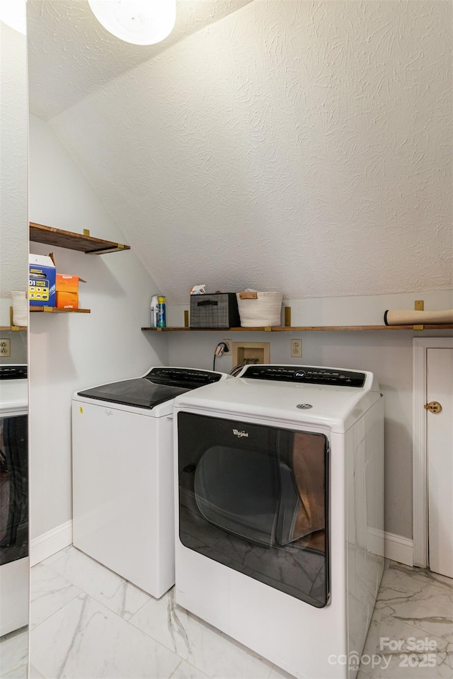 washroom with a textured ceiling and washing machine and clothes dryer