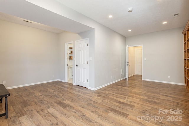 unfurnished room with hardwood / wood-style floors