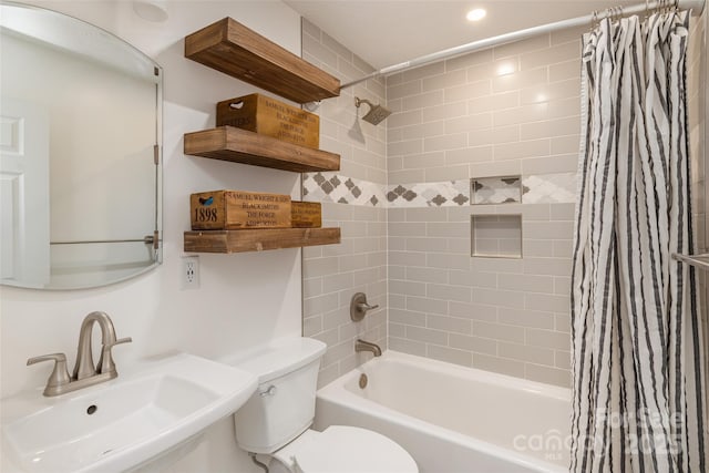 full bathroom featuring toilet, sink, and shower / tub combo