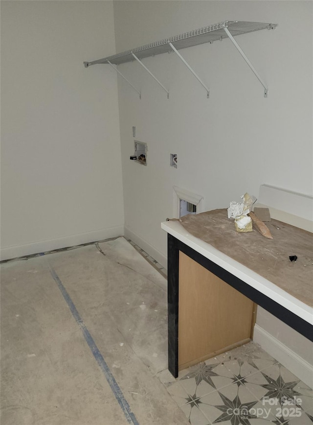 clothes washing area with baseboards and hookup for an electric dryer