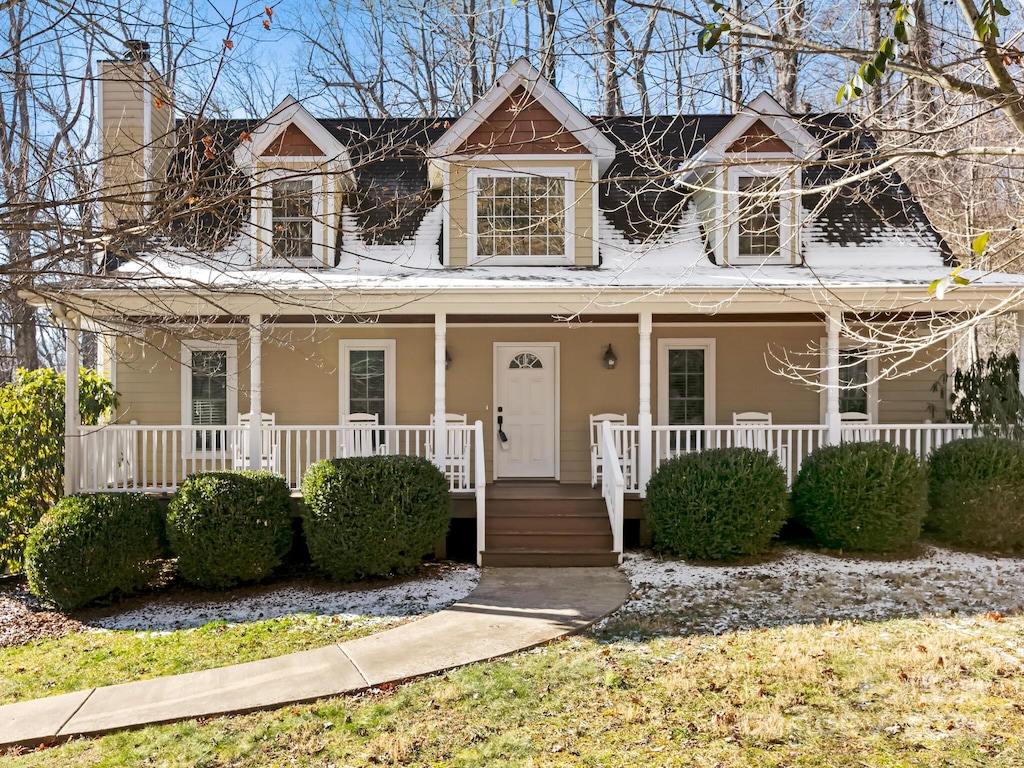 cape cod home with a porch